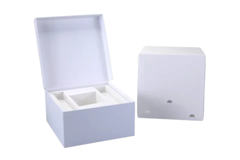 Two white custom rigid boxes: one is open revealing multiple compartments inside, and the other is closed, both set against a plain background.
