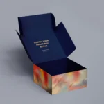 We are a manufacturer of custom box packaging. Please revise the following description to align with packaging terms and ensure it does not depict any text on the packaging:

"Open custom mailer box featuring a dark blue lid, complemented by a colorful abstract wave pattern along the sides, reminiscent of an aurora.