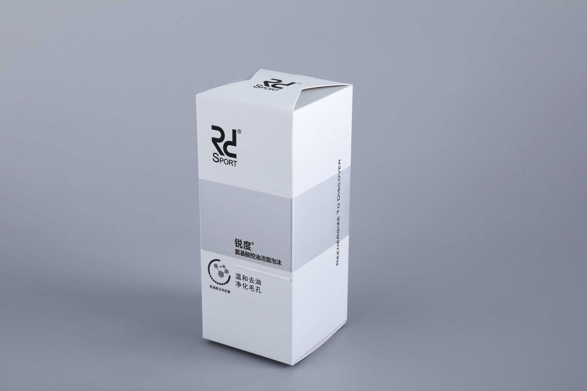 A custom-designed, tall rectangular box with a sleek white finish and branded elements, showcased against a neutral gray backdrop.