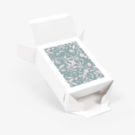 Open custom folding carton displaying floral insert and tuck-top closure mechanism
