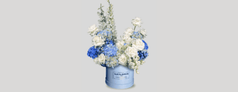 Floral custom box with white roses and blue hydrangeas.