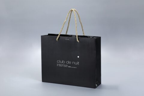 Our product is a custom black paper box with rope handles, designed with a minimalist gray background.
