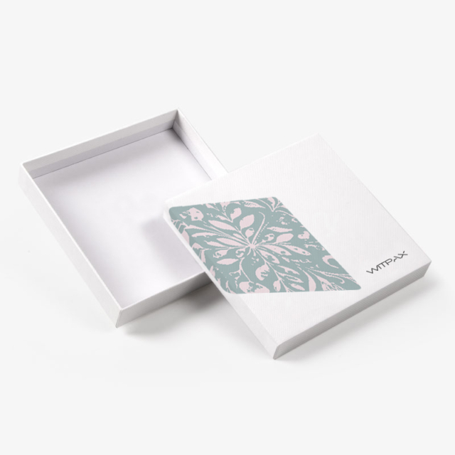 Custom shoulder and neck rigid box shown open with floral pattern panel on lid and white textured finish